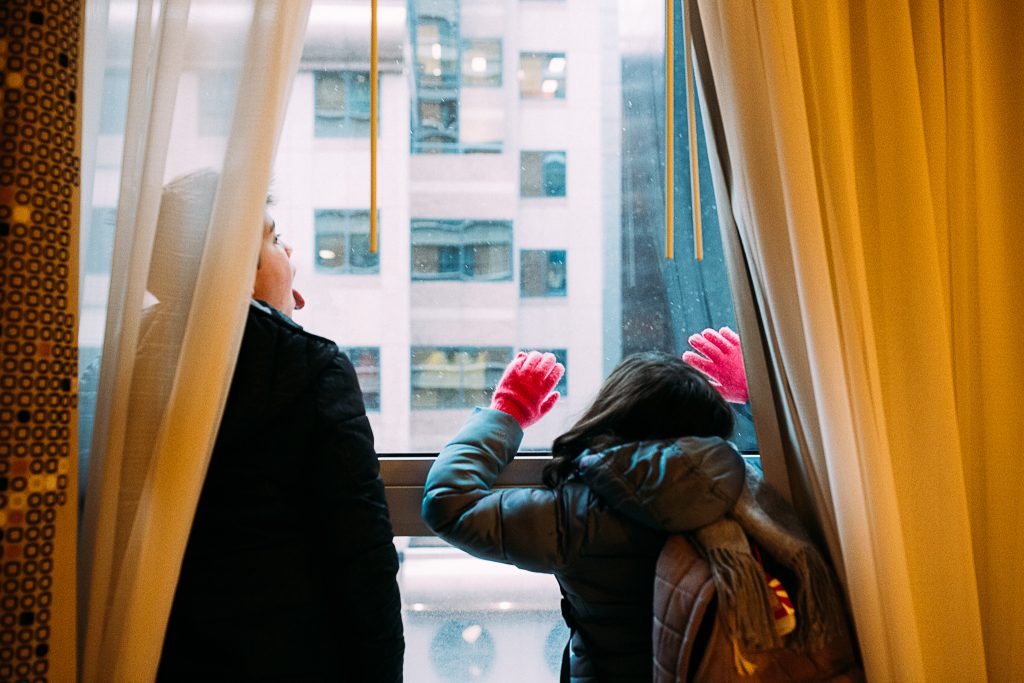 Children at the hotel’s window looking for snow