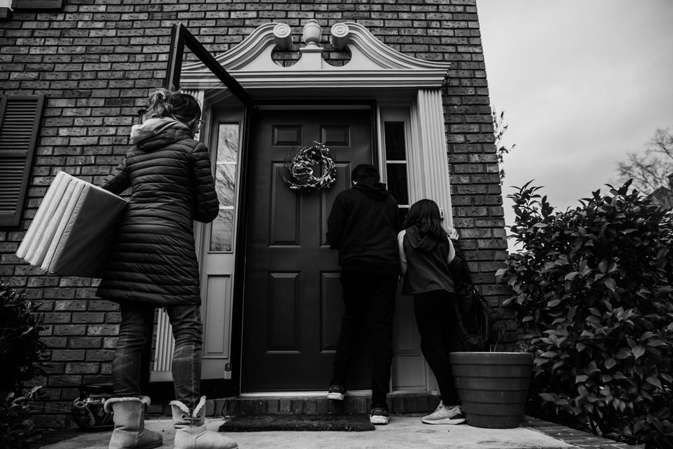 family at the front door of their house