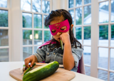 girl_eating_cucumber with a pink wonder woman mask