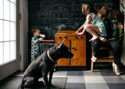 family in the kitchen with their black dog