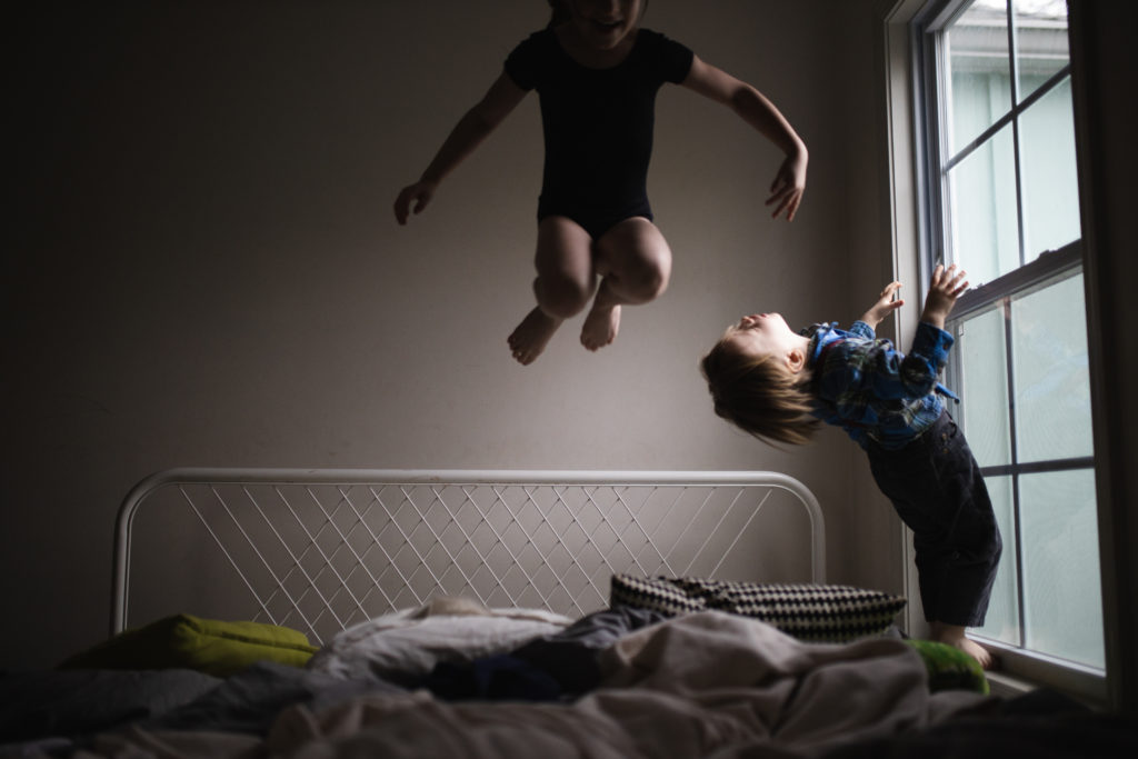 children jumping in the bed