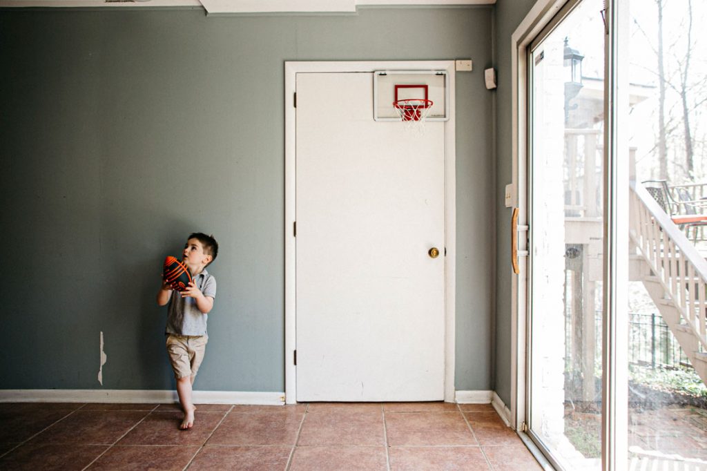 Kid playing basketball at home