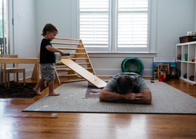 son and dad playing in the room