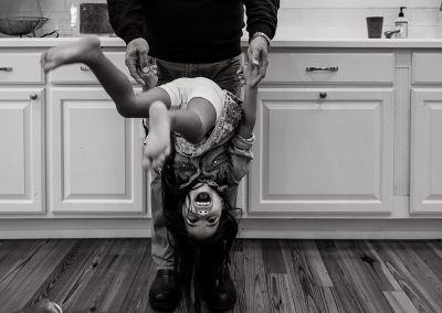 daughter playing in the kitchen with her dad